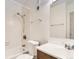 Bathroom featuring a tub with shower, tile surround, a white toilet, vanity, and a mirrored medicine cabinet at 5995 W Hampden Ave # 23, Denver, CO 80227