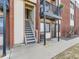Exterior view of an apartment entrance showing stairs and a balcony with a bicycle hanging on the railing at 5995 W Hampden Ave # 23, Denver, CO 80227