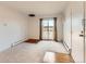 Living room with carpet, sliding glass doors to a balcony, baseboard heaters, and an air conditioning unit at 5995 W Hampden Ave # 23, Denver, CO 80227