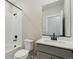 Modern bathroom featuring a walk-in shower, white subway tile, and gray vanity at 18318 E 93Rd Pl, Commerce City, CO 80022