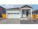 Charming single-Gathering home featuring an attached two-car garage and inviting front porch at 18318 E 93Rd Pl, Commerce City, CO 80022