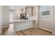 Well-lit kitchen featuring stainless steel appliances, white countertop, and hardwood floors at 18318 E 93Rd Pl, Commerce City, CO 80022