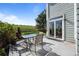 Outdoor patio with a view of a large grass field, with outdoor seating and glass sliding doors at 10519 Winterflower Way, Parker, CO 80134