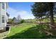 Expansive backyard with lush green grass, storage shed, landscaping, and a gentle slope at 10519 Winterflower Way, Parker, CO 80134