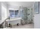 Modern bathroom featuring a soaking tub and glass enclosed tiled shower at 10519 Winterflower Way, Parker, CO 80134