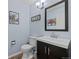 Powder room featuring a modern vanity, wall art, and classic fixtures at 10519 Winterflower Way, Parker, CO 80134