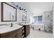 Spa-like bathroom with soaking tub, dual vanities, and tiled shower at 10519 Winterflower Way, Parker, CO 80134