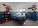 The bedroom is decorated with sports memorabilia and features a large window for natural light at 10519 Winterflower Way, Parker, CO 80134