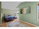 Inviting bedroom featuring light wood flooring, bay window and peaceful views at 10519 Winterflower Way, Parker, CO 80134