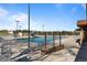 Large community pool with lifeguard stand, water slide, plenty of seating and trees in the background at 10519 Winterflower Way, Parker, CO 80134