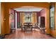 Elegant dining room featuring warm walls, tile floors, a chandelier, and a large window at 10519 Winterflower Way, Parker, CO 80134