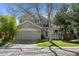 Charming two-story home featuring a stone facade, attached garage, and well-manicured lawn at 10519 Winterflower Way, Parker, CO 80134