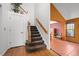 Bright foyer with hardwood floors, staircase, and doorway leading to the dining room at 10519 Winterflower Way, Parker, CO 80134