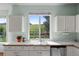 Bright kitchen with large windows above the stainless steel sink offering a view of green pastures at 10519 Winterflower Way, Parker, CO 80134