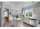 Bright kitchen featuring an island, stainless steel appliances, and large windows overlooking the scenic backyard at 10519 Winterflower Way, Parker, CO 80134