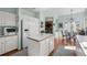 A bright and airy kitchen features an island, white cabinets, and stainless steel appliances at 10519 Winterflower Way, Parker, CO 80134