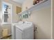 Convenient laundry room with washer, dryer, and shelving for ample storage at 10519 Winterflower Way, Parker, CO 80134
