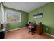 Comfortable office featuring hardwood floors, desk, and natural light from the window at 10519 Winterflower Way, Parker, CO 80134