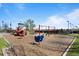 Community playground with slides, swings, and climbing structures provides a fun space for to play at 10519 Winterflower Way, Parker, CO 80134