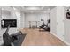 Basement gym includes a Peloton, weight rack and bar for functional fitness at 1301 Sidewinder Cir, Castle Rock, CO 80108