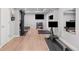 Spacious basement gym with wood floors, gym equipment, and a large TV at 1301 Sidewinder Cir, Castle Rock, CO 80108