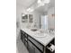 Bright bathroom featuring double sinks, a large mirror, and modern fixtures at 1301 Sidewinder Cir, Castle Rock, CO 80108