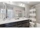 Bathroom with double sinks, white countertops, and a shower with neutral-striped curtain at 1301 Sidewinder Cir, Castle Rock, CO 80108
