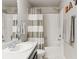 Bathroom showcasing single sink and shower with white subway tiles and neutral shower curtain at 1301 Sidewinder Cir, Castle Rock, CO 80108