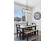 Bright dining area features stylish lighting, neutral decor, and a table with bench seating near a window at 1301 Sidewinder Cir, Castle Rock, CO 80108