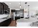 Gourmet kitchen boasts granite countertops, stainless steel appliances, dark wood cabinets, and open concept layout at 1301 Sidewinder Cir, Castle Rock, CO 80108