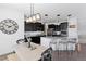 A spacious kitchen with dark cabinetry, a center island with barstool seating, and a rustic wood dining table at 1301 Sidewinder Cir, Castle Rock, CO 80108