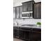 Close-up of a kitchen showcasing dark wood cabinets, granite countertops, subway tile backsplash, and stainless appliances at 1301 Sidewinder Cir, Castle Rock, CO 80108