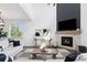 Living room features a modern fireplace, vaulted ceilings and natural light from a large window at 1301 Sidewinder Cir, Castle Rock, CO 80108