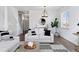 Open-concept living room with modern furnishings, shiplap accent wall, and staircase view at 1301 Sidewinder Cir, Castle Rock, CO 80108