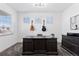 Home office with a large desk, guitars on the wall, and ample natural light from three windows at 1301 Sidewinder Cir, Castle Rock, CO 80108