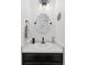 Stylish powder room featuring modern fixtures, oval mirror, and black accents at 1301 Sidewinder Cir, Castle Rock, CO 80108