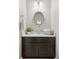 Stylish powder room with a dark vanity, oval mirror, and fresh decor at 1301 Sidewinder Cir, Castle Rock, CO 80108