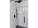 Walk-in shower featuring sleek marble tile and modern black shower head and handle at 1301 Sidewinder Cir, Castle Rock, CO 80108