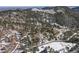 An aerial view showcases the property's expansive forested land and mountain setting at 4398 Cameyo Rd, Indian Hills, CO 80454