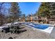 Spacious backyard with pool, lounge seating, and a view of the grand home at 4398 Cameyo Rd, Indian Hills, CO 80454
