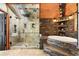 Bathroom featuring a tiled shower, soaking tub, and skylight at 4398 Cameyo Rd, Indian Hills, CO 80454