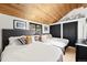 Comfortable bedroom with vaulted ceilings and a scenic outdoor view from window at 4398 Cameyo Rd, Indian Hills, CO 80454