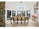 Bright dining room with floor to ceiling windows, a unique chandelier, and seating for eight makes dining enjoyable at 4398 Cameyo Rd, Indian Hills, CO 80454