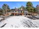 Sprawling exterior view showcasing the home, the outdoor space, and the surrounding greenery at 4398 Cameyo Rd, Indian Hills, CO 80454
