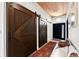 Inviting foyer with elegant sliding barn doors, hardwood floors, and a stylish bench, creating a warm and welcoming entrance at 4398 Cameyo Rd, Indian Hills, CO 80454