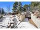 Unique underground garage entrance surrounded by natural rock formations in the snowy terrain at 4398 Cameyo Rd, Indian Hills, CO 80454