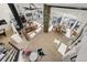 Spacious living room area featuring large windows, a stone fireplace, and wood flooring at 4398 Cameyo Rd, Indian Hills, CO 80454