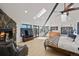 Main bedroom with fireplace, wood floors, and large windows with a view at 4398 Cameyo Rd, Indian Hills, CO 80454