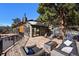A luxurious outdoor deck featuring modern furniture, a fire pit, and stunning architectural details of the home at 4398 Cameyo Rd, Indian Hills, CO 80454