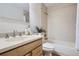 Bathroom featuring neutral tones, a single sink vanity with stone countertop, and a shower/tub combo at 5511 S Lowell Blvd, Littleton, CO 80123